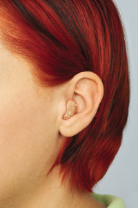 woman with half shell hearing aid